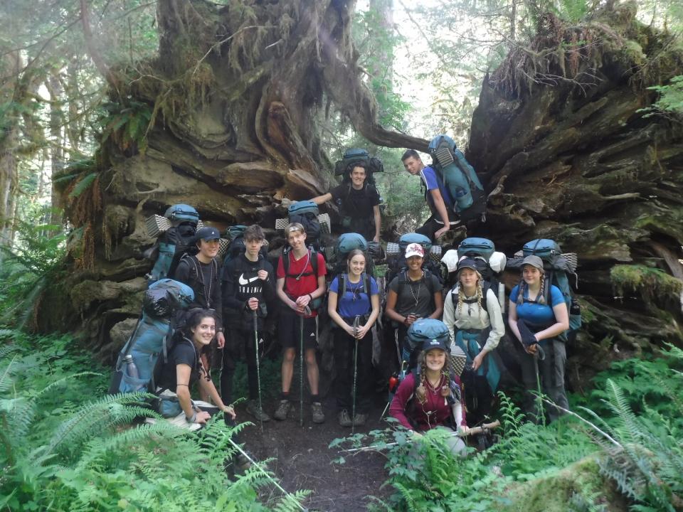 Olympic Alcoa Scholars group photo in front of a massive tree root
